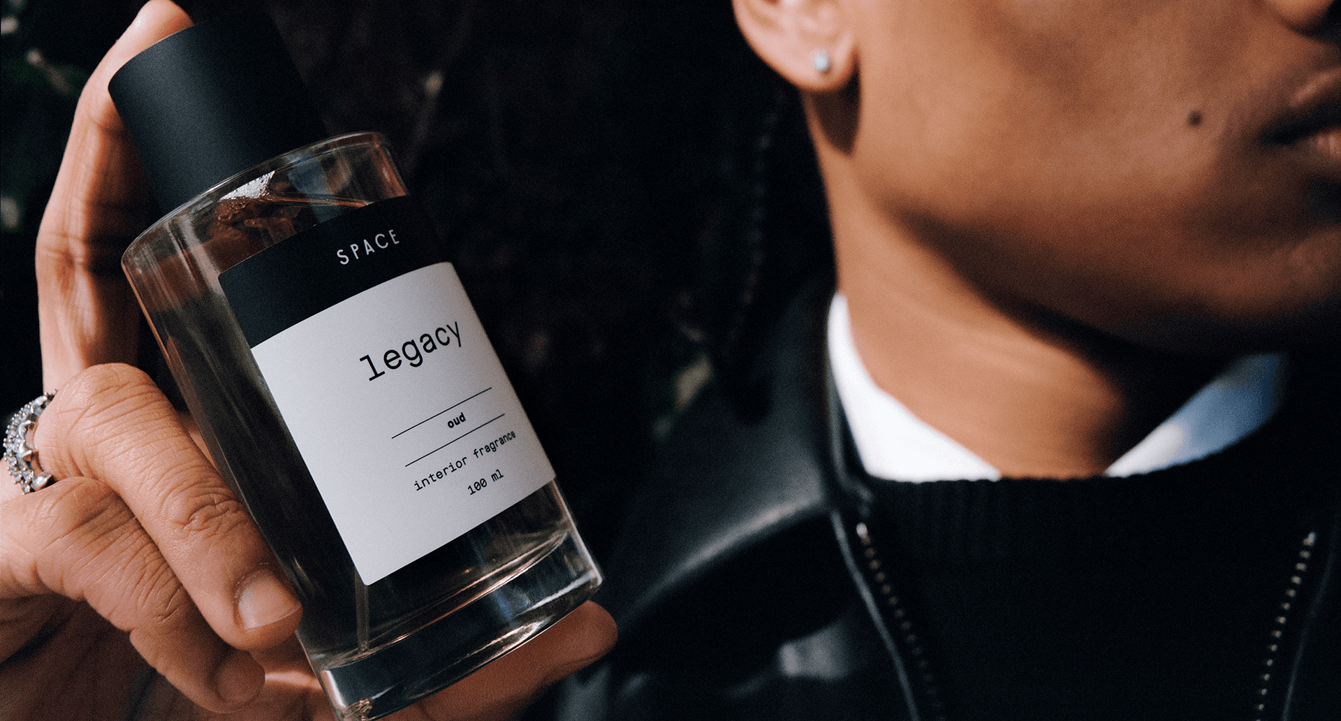 Legacy fragrance bottle held in hand
